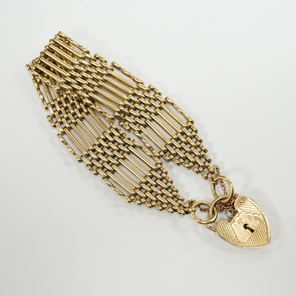 A 1960's 9ct gold gate link bracelet, with heart shaped padlock clasp, 17cm